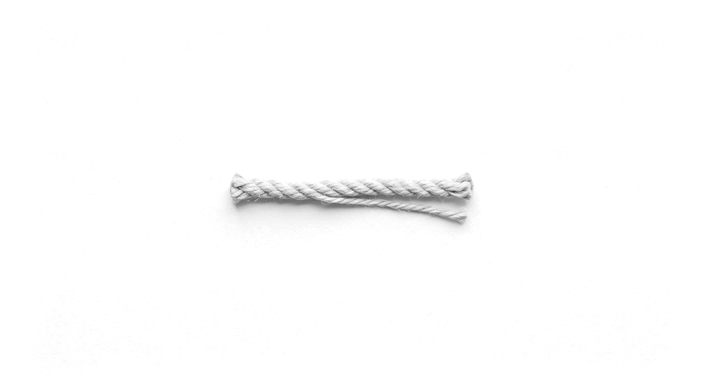 A braided rope with one strand lifting away from the braid